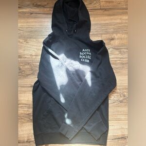 Black hoodie with a grey logo on the front and a grey logo on the back.